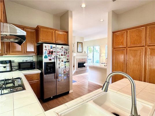 Fireplace, Interior, Kitchen, Recessed Lighting, Tile Countertops, Wood Texture Flooring