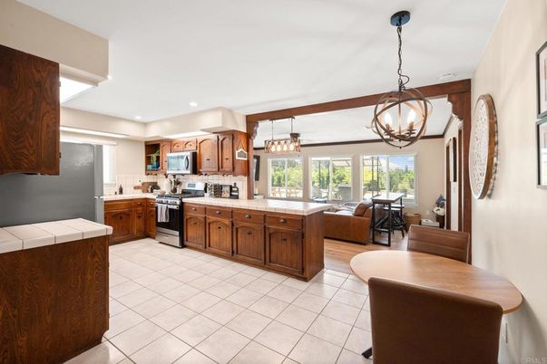 Chandelier, Dining room, Interior, Kitchen, Living room, Pendant Lights, Recessed Lighting, Stainless Steel Appliances, Tile Countertops