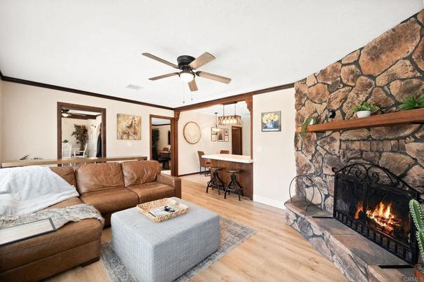 Chandelier, Fireplace, Interior, Living room, Pendant Lights, Stone Walls, Wood Texture Flooring