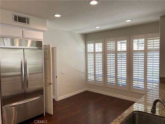 Empty room, Interior, Kitchen, Recessed Lighting, Stainless Steel Appliances, Wood Texture Flooring