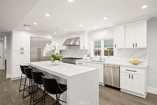 Interior, Kitchen, Marble Walls, Recessed Lighting, Stainless Steel Appliances, Wood Texture Flooring