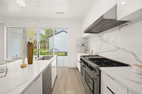 Interior, Kitchen, Marble Walls, Recessed Lighting, Stainless Steel Appliances, Wood Texture Flooring
