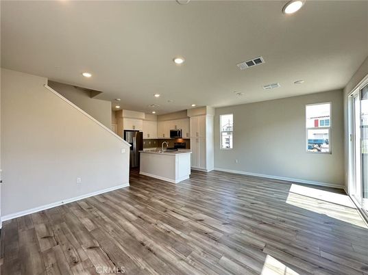 Empty room, Interior, Kitchen, Recessed Lighting, Stainless Steel Appliances, Wood Texture Flooring
