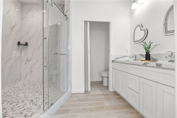 Bathroom, Dual Sink Vanities, Glass Shower, Interior, Marble Walls, Wood Texture Flooring