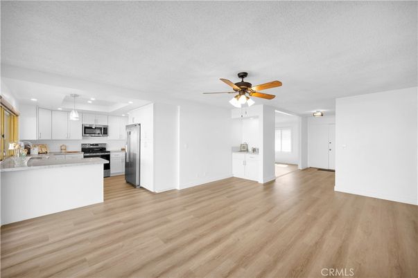 Empty room, Interior, Kitchen, Pendant Lights, Recessed Lighting, Stainless Steel Appliances, Wood Texture Flooring