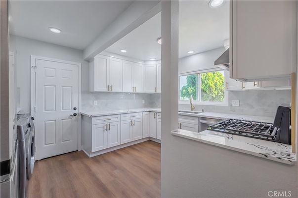 Interior, Kitchen, Recessed Lighting, Washer, Wood Texture Flooring