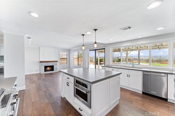 Fireplace, Interior, Kitchen, Pendant Lights, Recessed Lighting, Stainless Steel Appliances, Wood Texture Flooring