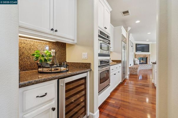 Fireplace, Interior, Kitchen, Recessed Lighting, Stainless Steel Appliances, Wood Texture Flooring