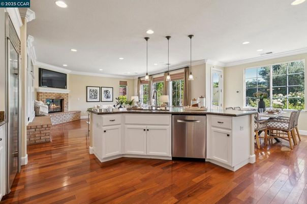 Dining room, Fireplace, Interior, Kitchen, Pendant Lights, Recessed Lighting, Stainless Steel Appliances, Wood Texture Flooring