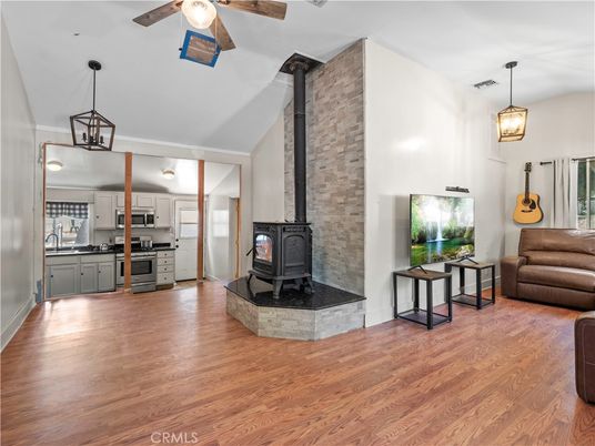 Fireplace, Interior, Kitchen, Pendant Lights, Stainless Steel Appliances, Stone Walls, Wood Texture Flooring