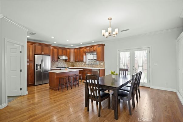 Chandelier, Dining room, Interior, Kitchen, Recessed Lighting, Stainless Steel Appliances, Wood Texture Flooring