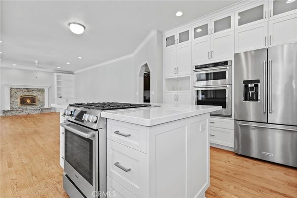 Fireplace, Interior, Kitchen, Recessed Lighting, Stainless Steel Appliances, Wood Texture Flooring