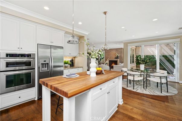 Dining room, Fireplace, Interior, Kitchen, Pendant Lights, Recessed Lighting, Stainless Steel Appliances, Wood Texture Flooring