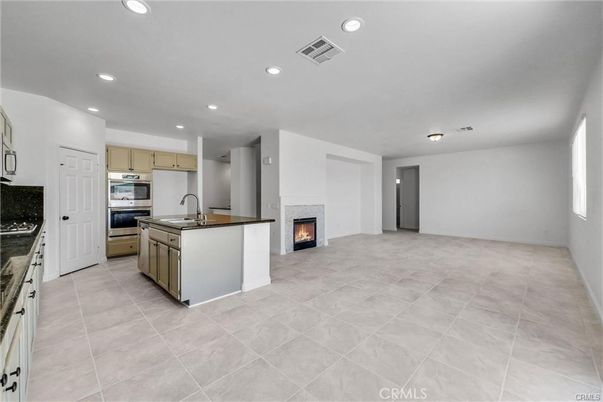 Empty room, Fireplace, Interior, Kitchen, Recessed Lighting, Stainless Steel Appliances