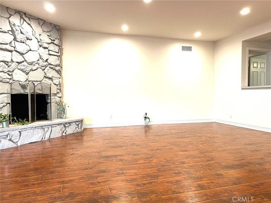 Empty room, Fireplace, Interior, Recessed Lighting, Stone Walls, Wood Texture Flooring