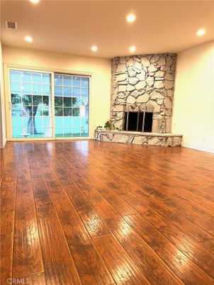 Empty room, Fireplace, Interior, Recessed Lighting, Stone Walls, Wood Texture Flooring