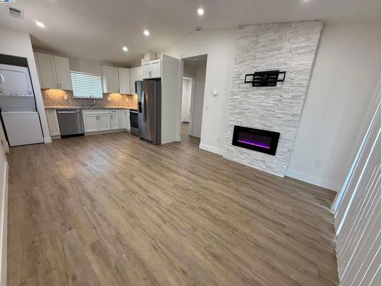 Fireplace, Interior, Kitchen, Recessed Lighting, Stainless Steel Appliances, Stone Walls, Wood Texture Flooring