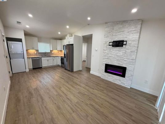 Fireplace, Interior, Kitchen, Recessed Lighting, Stainless Steel Appliances, Stone Walls, Wood Texture Flooring