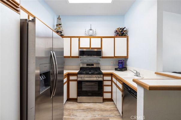 Interior, Kitchen, Stainless Steel Appliances, Tile Countertops, Wood Texture Flooring