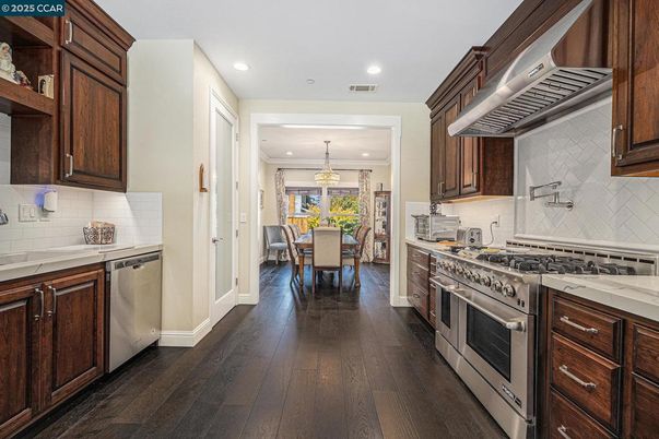 Chandelier, Dining room, Interior, Kitchen, Pendant Lights, Recessed Lighting, Stainless Steel Appliances, Wood Texture Flooring