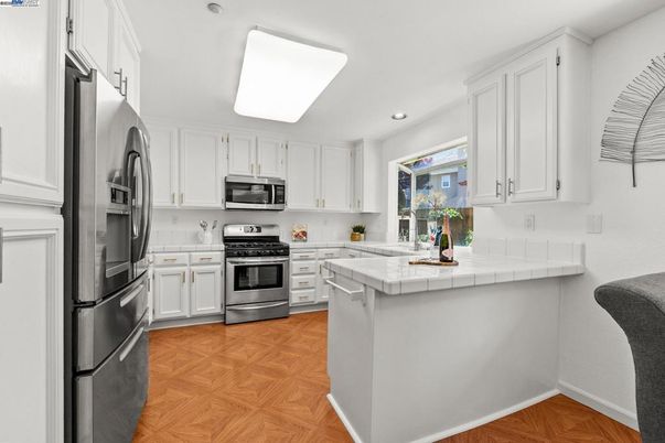 Interior, Kitchen, Recessed Lighting, Stainless Steel Appliances, Tile Countertops, Wood Texture Flooring