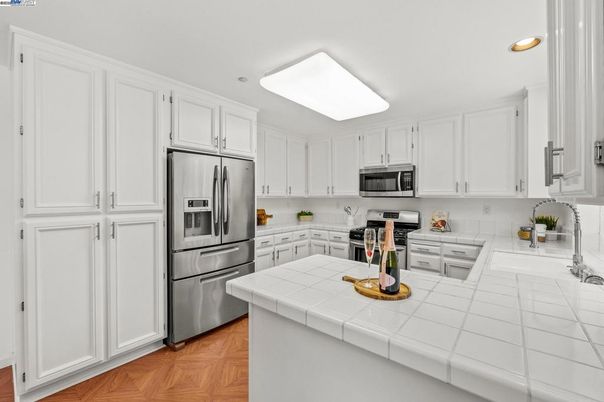 Interior, Kitchen, Recessed Lighting, Stainless Steel Appliances, Tile Countertops, Wood Texture Flooring