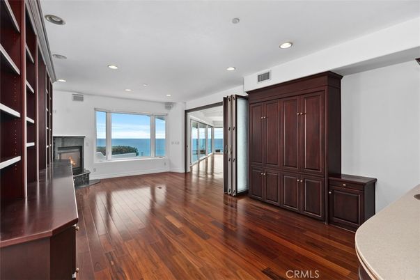 Empty room, Fireplace, Interior, Recessed Lighting, Water, Wood Texture Flooring