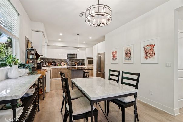 Chandelier, Dining room, Interior, Kitchen, Pendant Lights, Recessed Lighting, Stainless Steel Appliances, Wood Texture Flooring
