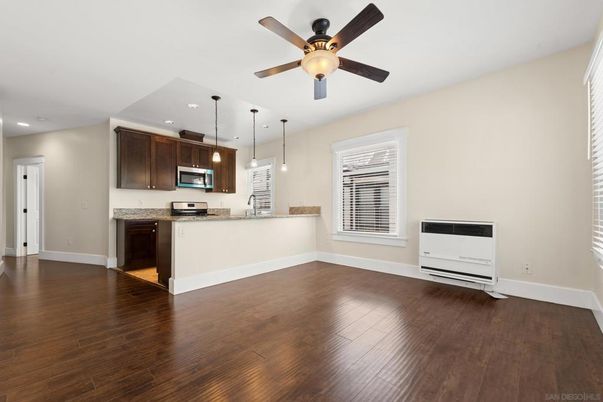 Empty room, Interior, Kitchen, Pendant Lights, Recessed Lighting, Stainless Steel Appliances, Wood Texture Flooring
