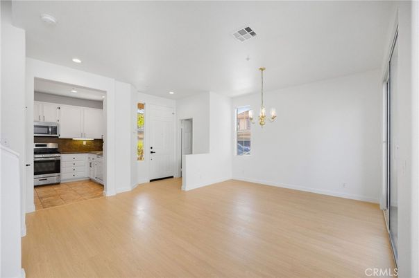 Chandelier, Empty room, Interior, Kitchen, Recessed Lighting, Stainless Steel Appliances, Wood Texture Flooring