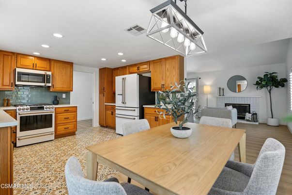 Dining room, Fireplace, Interior, Kitchen, Living room, Recessed Lighting, Stainless Steel Appliances, Wood Texture Flooring