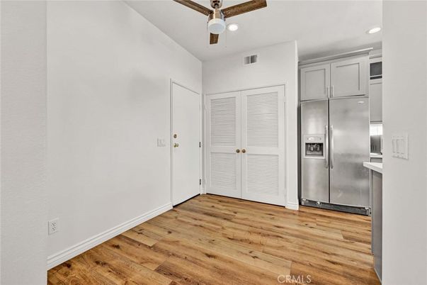 Empty room, Interior, Kitchen, Recessed Lighting, Stainless Steel Appliances, Wood Texture Flooring