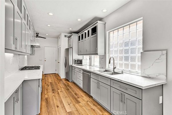 Interior, Kitchen, Marble Walls, Recessed Lighting, Stainless Steel Appliances, Wood Texture Flooring