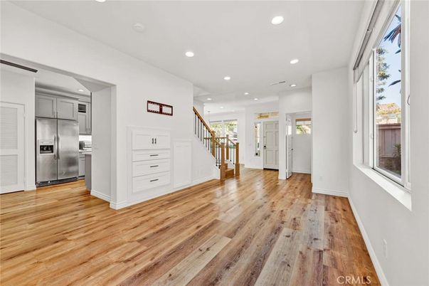 Empty room, Interior, Kitchen, Recessed Lighting, Stainless Steel Appliances, Wood Texture Flooring
