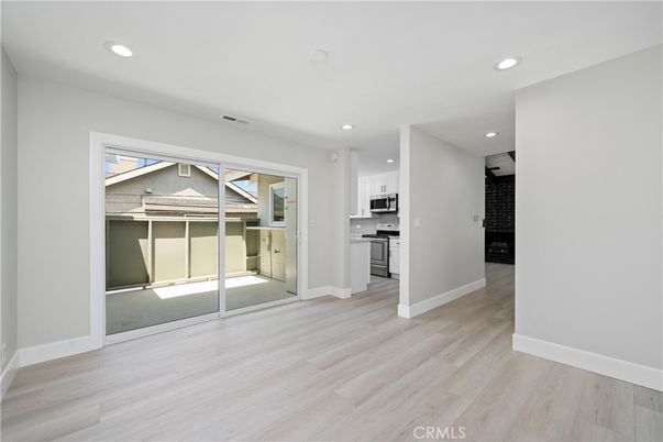Empty room, Interior, Kitchen, Recessed Lighting, Stainless Steel Appliances, Wood Texture Flooring