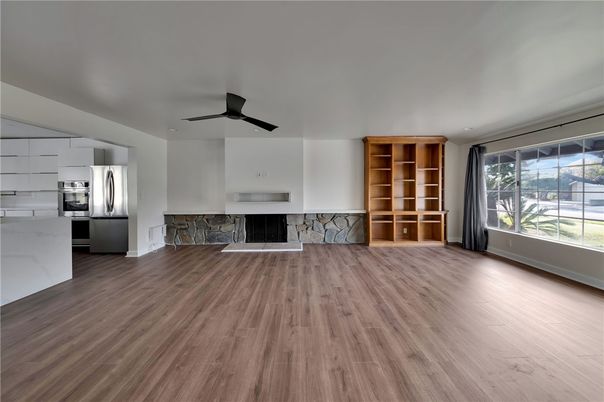 Empty room, Fireplace, Interior, Kitchen, Stainless Steel Appliances, Wood Texture Flooring
