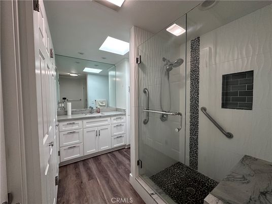 Bathroom, Dual Sink Vanities, Glass Shower, Interior, Recessed Lighting, Wood Texture Flooring