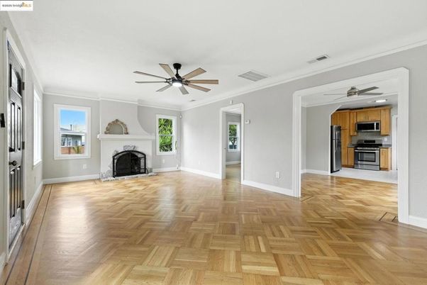 Empty room, Fireplace, Interior, Kitchen, Stainless Steel Appliances, Wood Texture Flooring