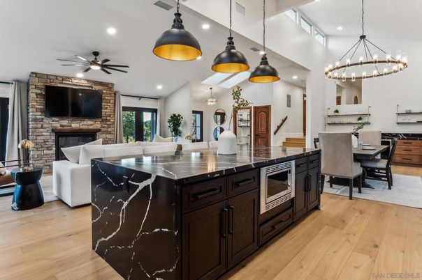 Chandelier, Dining room, Fireplace, Interior, Kitchen, Living room, Pendant Lights, Recessed Lighting, Stone Walls, Wood Texture Flooring