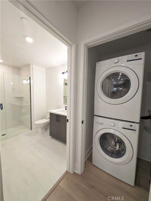 Bathroom, Glass Shower, Interior, Recessed Lighting, Utility Closets, Washer, Wood Texture Flooring