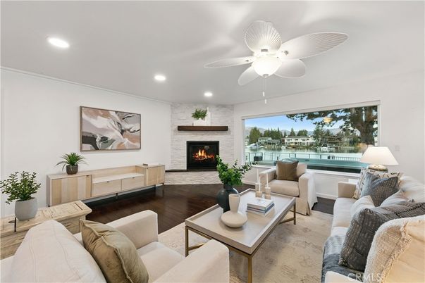 Fireplace, Interior, Living room, Recessed Lighting, Stone Walls, Water, Wood Texture Flooring