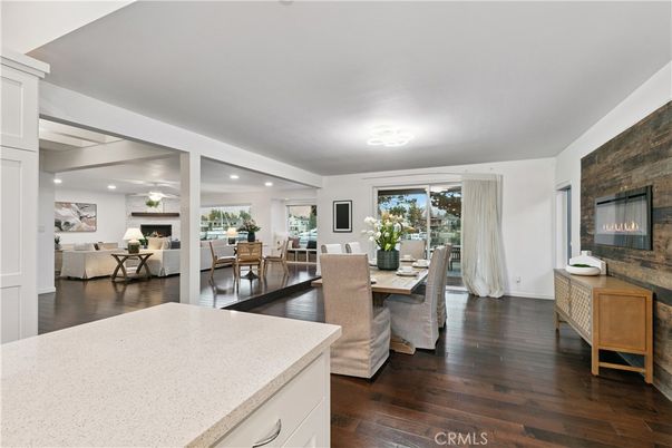 Dining room, Fireplace, Interior, Living room, Recessed Lighting, Stone Walls, Wood Texture Flooring