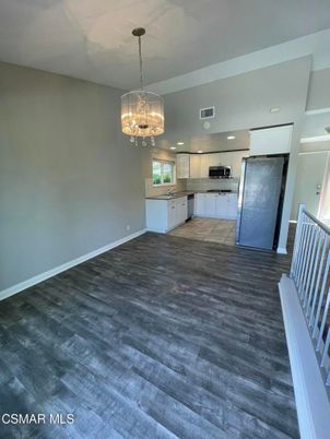Chandelier, Empty room, Interior, Kitchen, Recessed Lighting, Stainless Steel Appliances, Wood Texture Flooring
