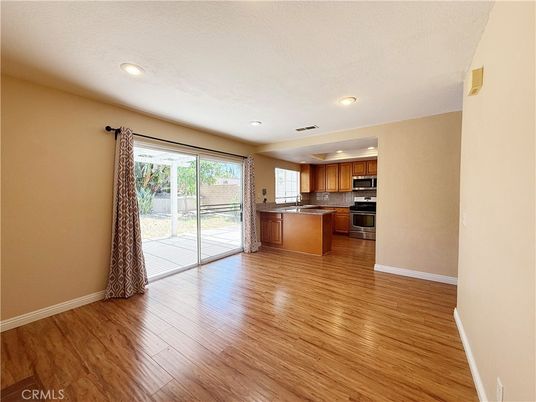 Empty room, Interior, Kitchen, Recessed Lighting, Stainless Steel Appliances, Wood Texture Flooring
