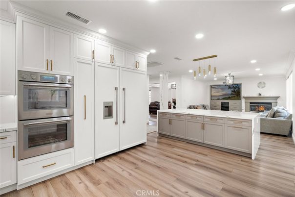 Fireplace, Interior, Kitchen, Living room, Pendant Lights, Recessed Lighting, Stainless Steel Appliances, Wood Texture Flooring