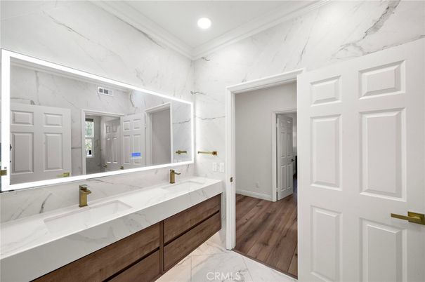 Bathroom, Dual Sink Vanities, Interior, Marble, Marble Walls, Recessed Lighting, Wood Texture Flooring