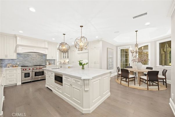 Chandelier, Dining room, Interior, Kitchen, Recessed Lighting, Stainless Steel Appliances, Wood Texture Flooring