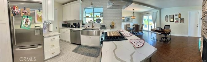 Dining room, Fireplace, Interior, Kitchen, Pendant Lights, Stainless Steel Appliances, Stone Walls, Wood Texture Flooring