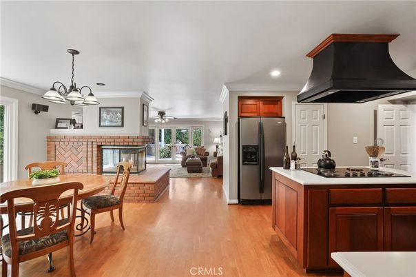 Chandelier, Dining room, Fireplace, Interior, Kitchen, Living room, Pendant Lights, Recessed Lighting, Stainless Steel Appliances, Wood Texture Flooring