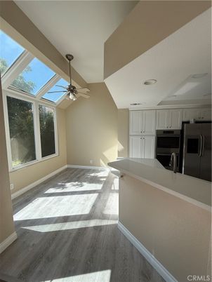 Empty room, Interior, Kitchen, Recessed Lighting, Stainless Steel Appliances, Wood Texture Flooring